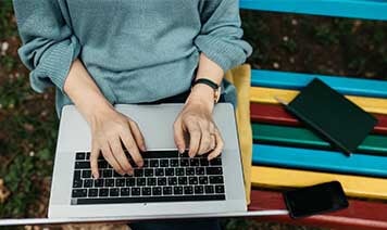 woman at home looking at laptop